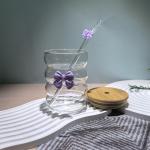 Elegant glass cup with lid and straw