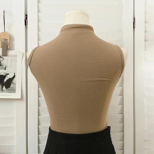 High-neck vest with chest pads. Style and comfort in one piece.